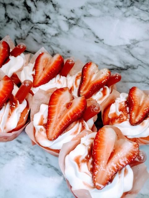 Tray of strawberry Cupcake Shots with red pipettes